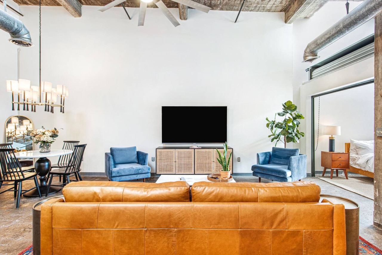 Loft with natural skylights. Open concept kitchen with bar seating & dining table, perfect for guests cooking & entertaining.