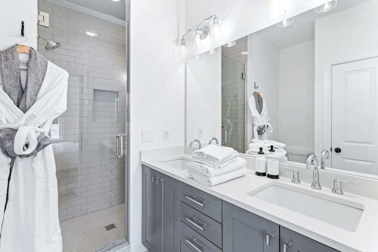 Private primary bathroom with modern fixtures & finishes, & include plenty of plush robes, towels, & toiletries for your convenience.