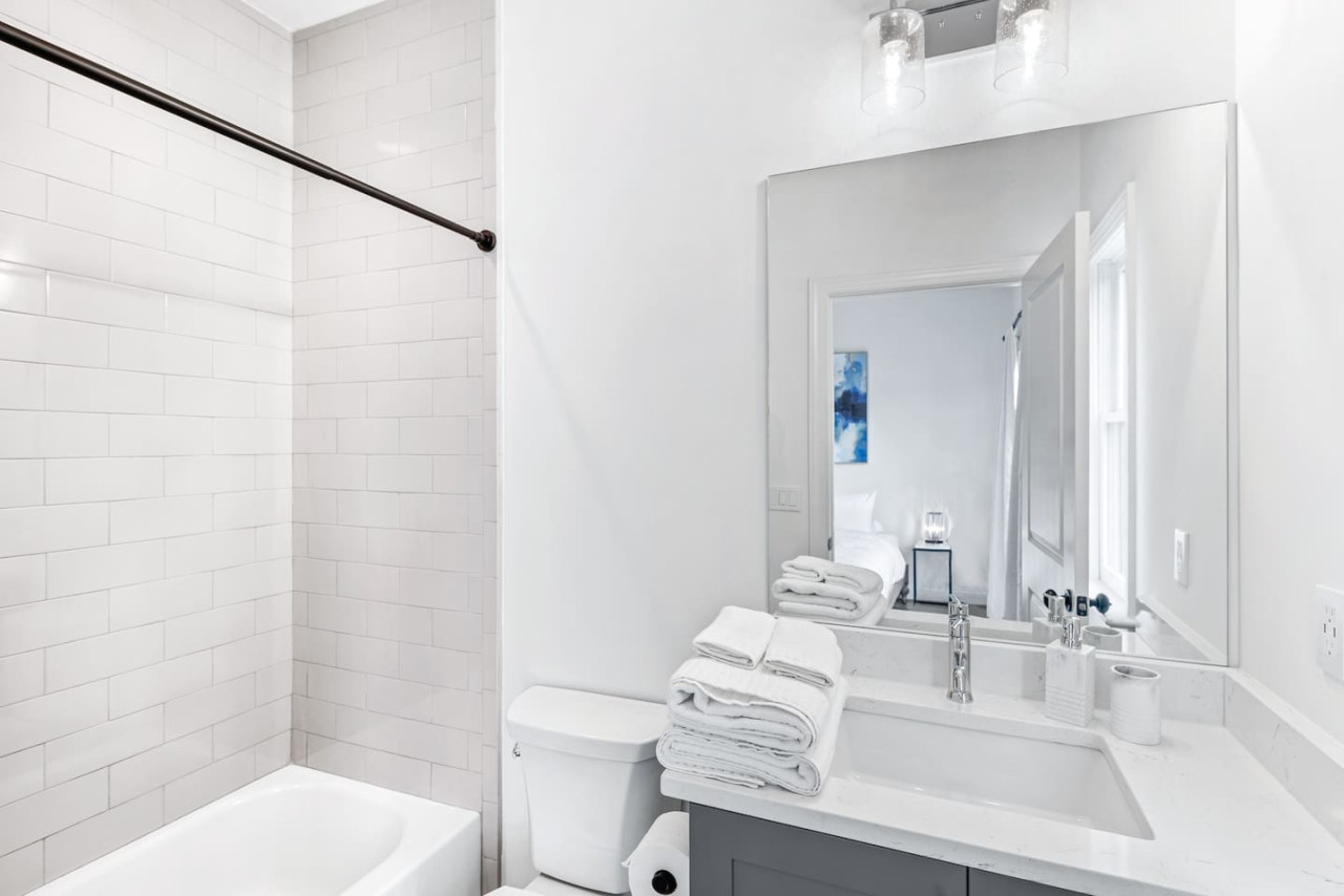 Private guest bathroom with modern fixtures & finishes, & include plenty of plush robes, towels, & toiletries for your convenience.