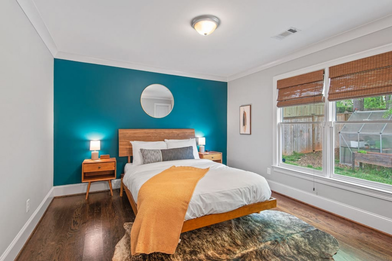 Primary bedroom with queen-sized bed, en suite bathroom with walk-in shower, and walk-in closet.