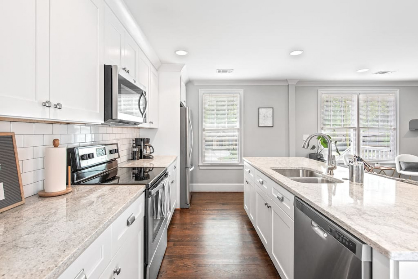 Chef's kitchen with bar seating, granite countertops, and fully stocked with all your basic cooking items!