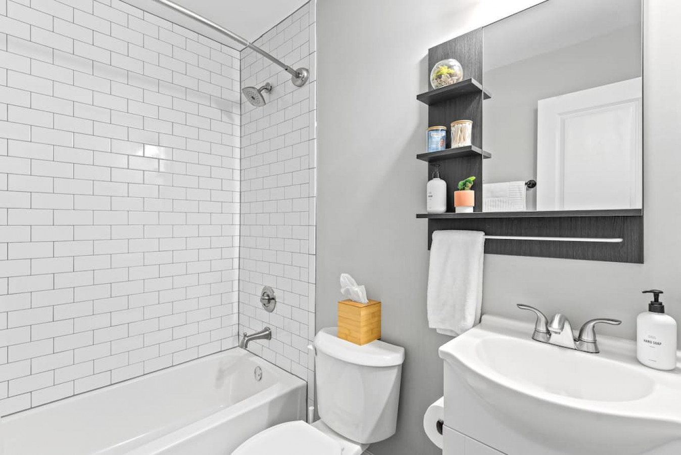 Second full bathroom with shower/tub combo and Public Goods hair/body products.