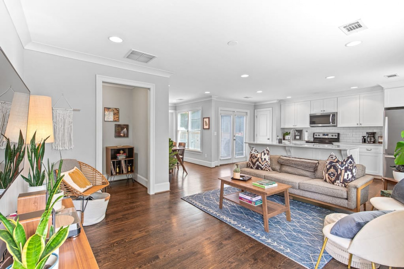 Open concept living space with mid-century style furniture, record player and 52" Smart TV.