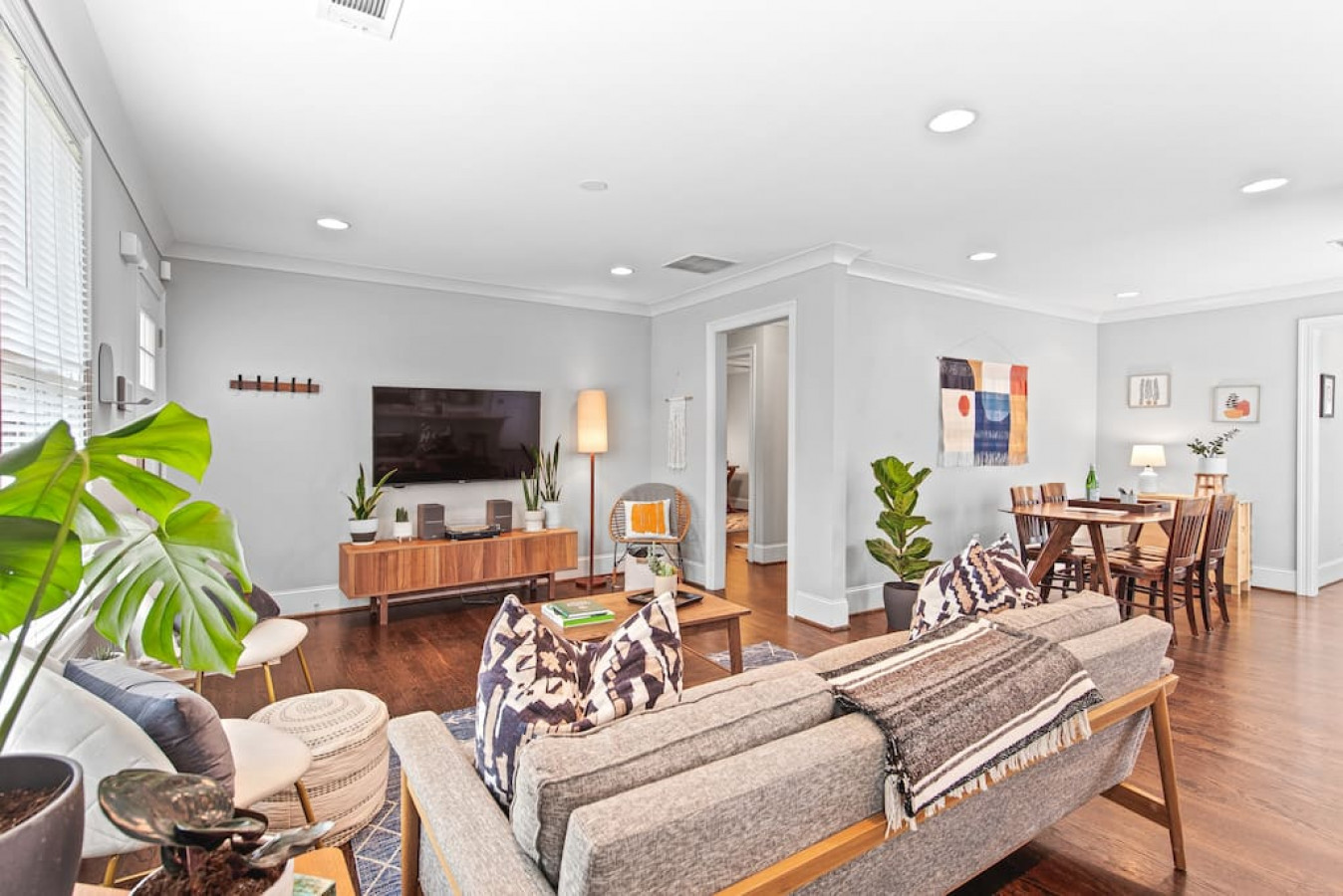 Open concept living space with mid-century style furniture, record player and 52" Smart TV.