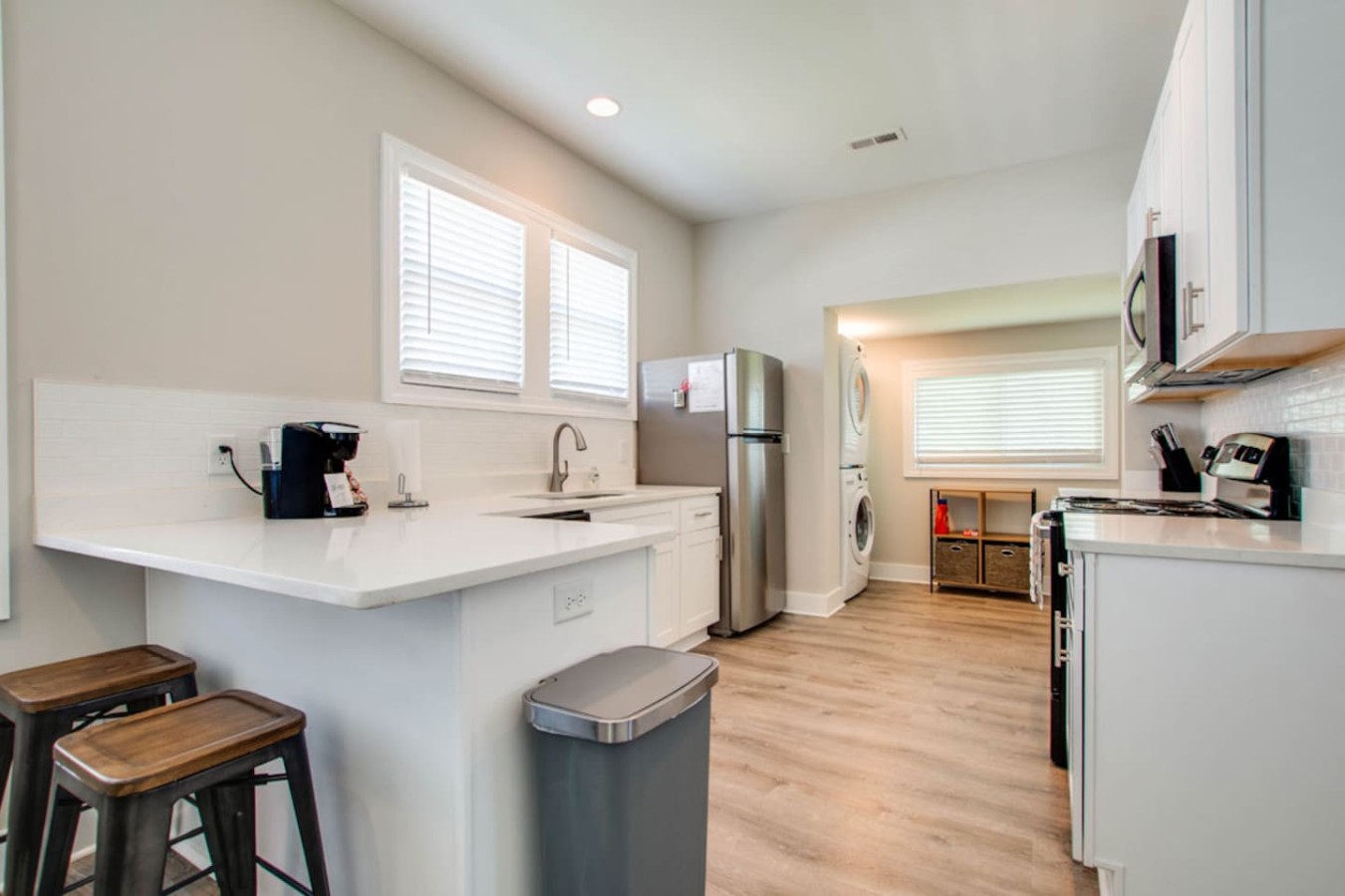 Bright Kitchen & Laundry Area
Enjoy a fully stocked kitchen with bar seating, Keurig coffee maker, and stainless appliances—plus the added convenience of in-unit washer and dryer just steps away.