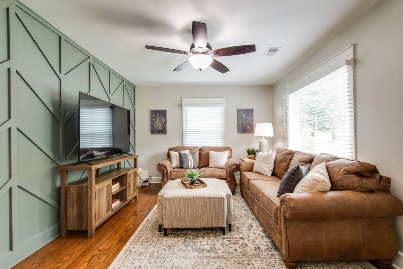 Your Murfreesboro retreat awaits! Dive into relaxation with a deluxe 65-inch TV, flexible sleeping arrangements on a pull-out sofa, and an accent wall that adds a touch of sophistication to the cozy charm of our living room.