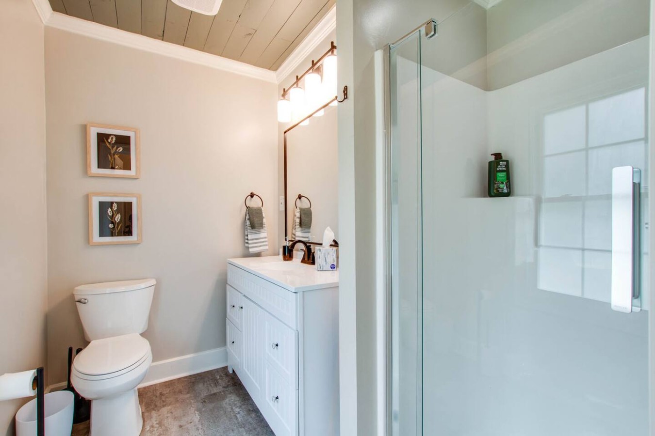 Discover the allure of the master bath, adorned with tasteful decor that seamlessly combines elegance and functionality. The chic design creates a welcoming atmosphere, and the shower provides a revitalizing escape for a truly pampering stay