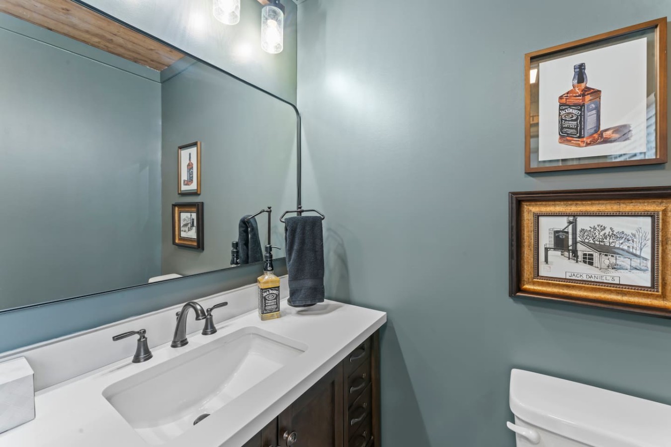 The master bathroom vanity exudes modern elegance with a sleek granite countertop and ample storage. The well-lit mirror enhances the space, offering a chic and functional area for your daily grooming rituals.