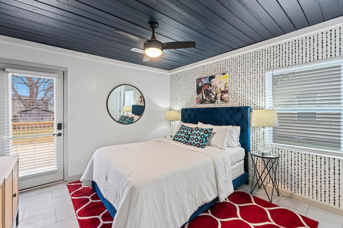 Immerse yourself in Elvis-inspired charm in our master bedroom. Decked in soothing blue hues, enjoy a cozy queen-size bed and a unique touch of musical history. Open the door to a private back deck for a serene retreat.