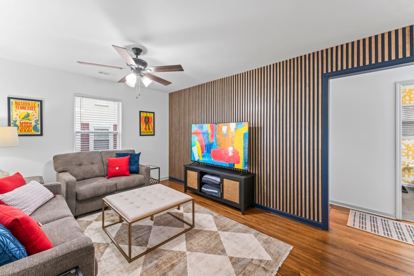 Spacious living room with 65-inch TV and convertible sofa bed