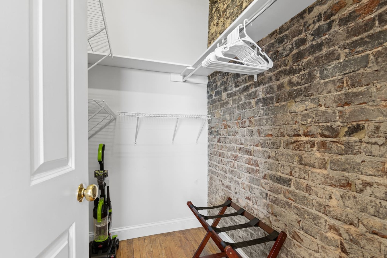 Enjoy the convenience of a spacious closet just off the bedroom, complete with plenty of hanging space and storage. The exposed brick wall adds a unique touch, blending functionality with the loft’s charming, rustic aesthetic.