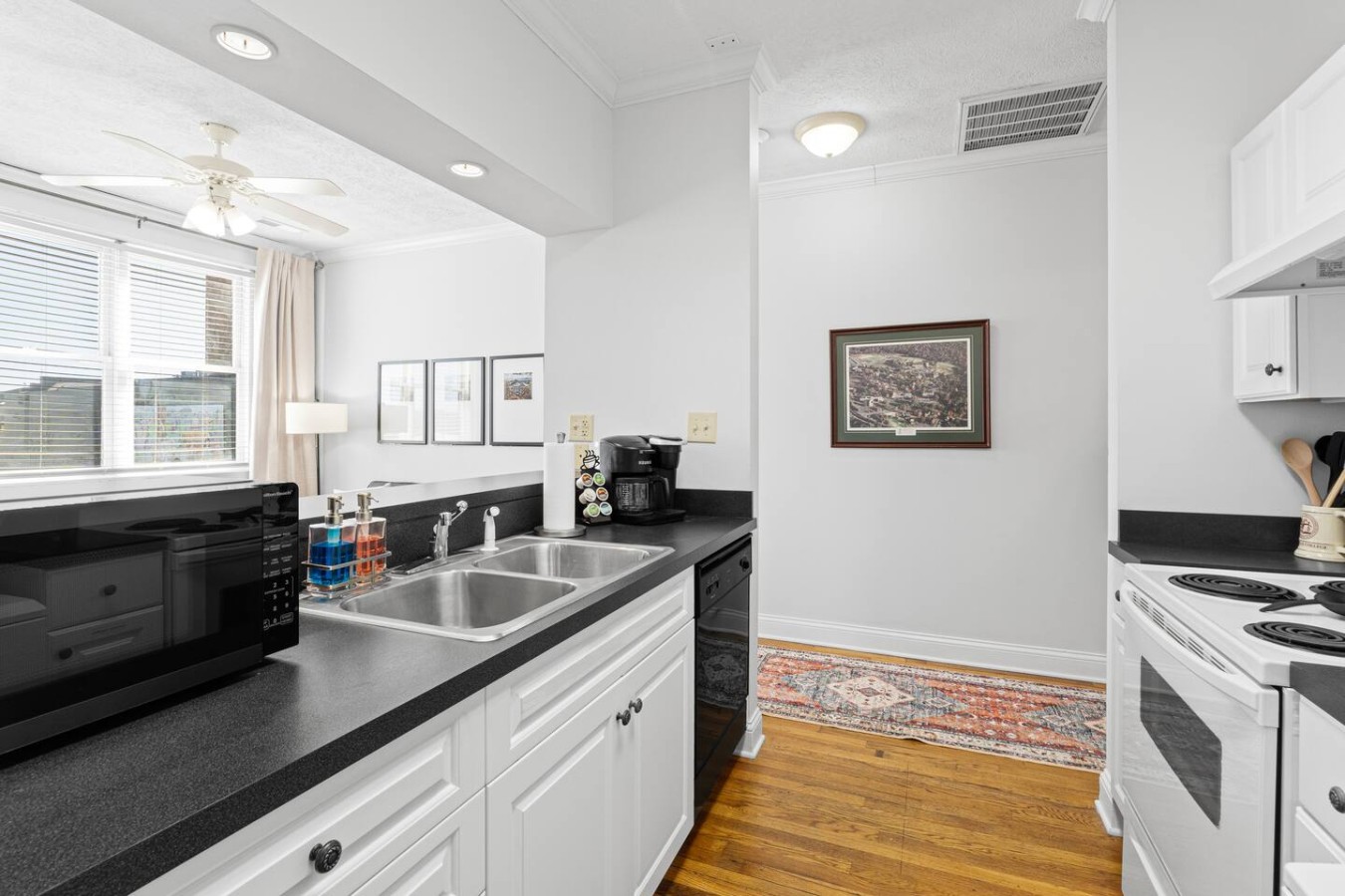 Bright and functional, this kitchen offers all the essentials for a great stay, from a Keurig coffee maker to a microwave and dishwasher. The open design allows for easy flow between the kitchen and living area, making it perfect for socializing whil