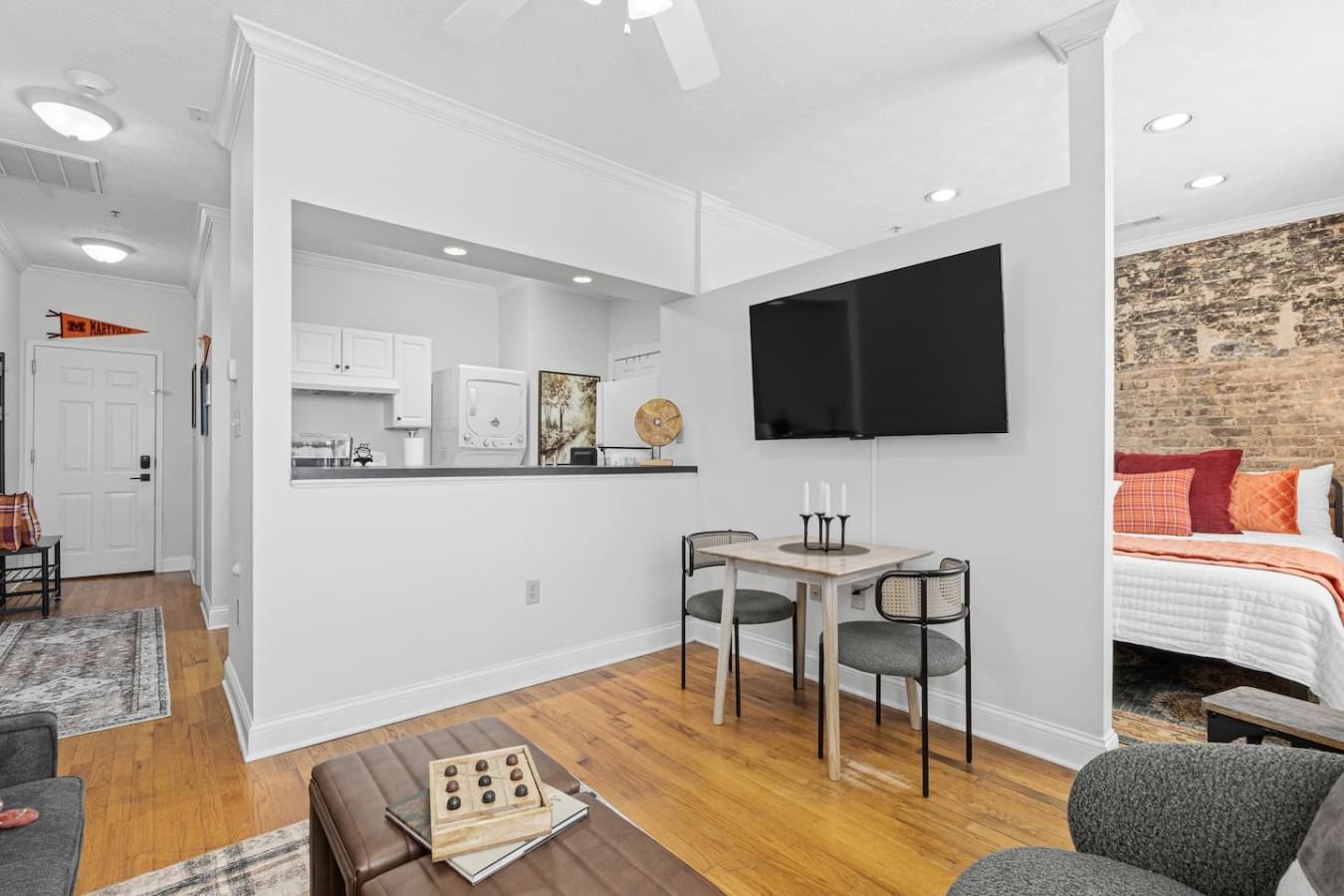 The open layout of the Scots Suite features a cozy bedroom just off the living area, with no door or full enclosure, creating an airy, loft-style feel. Though open, this design offers comfort and charm while keeping the space bright and inviting.