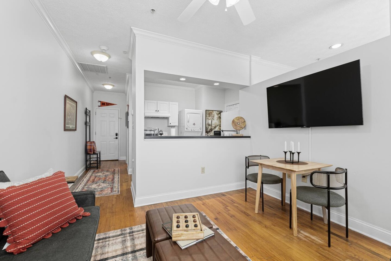 The Scots Suite offers an inviting open-concept layout with a convenient kitchen pass-through, perfect for casual meals or movie nights. The sleek dining nook is ideal for two, and the mounted flat-screen TV ensures you stay entertained in style.