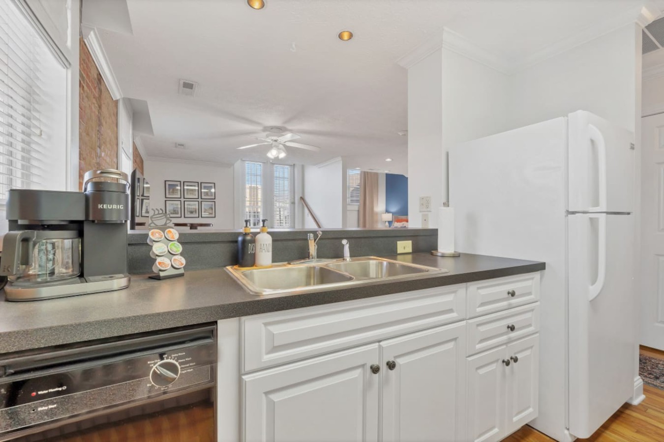 Fully equipped kitchen featuring a double sink, Keurig coffee station, and sleek appliances. A comfortable setup for both short and long stays.