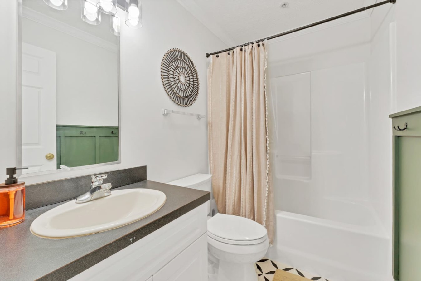 Bright and modern full bathroom featuring a spacious vanity, tub-shower combo, and fresh linens. A clean, comfortable space designed for relaxation after a day exploring downtown Maryville.