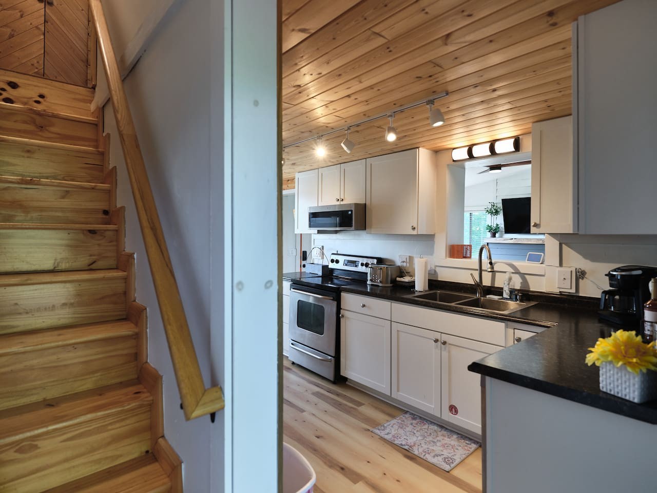 Access to the additional sleeping area is just off the kitchen.