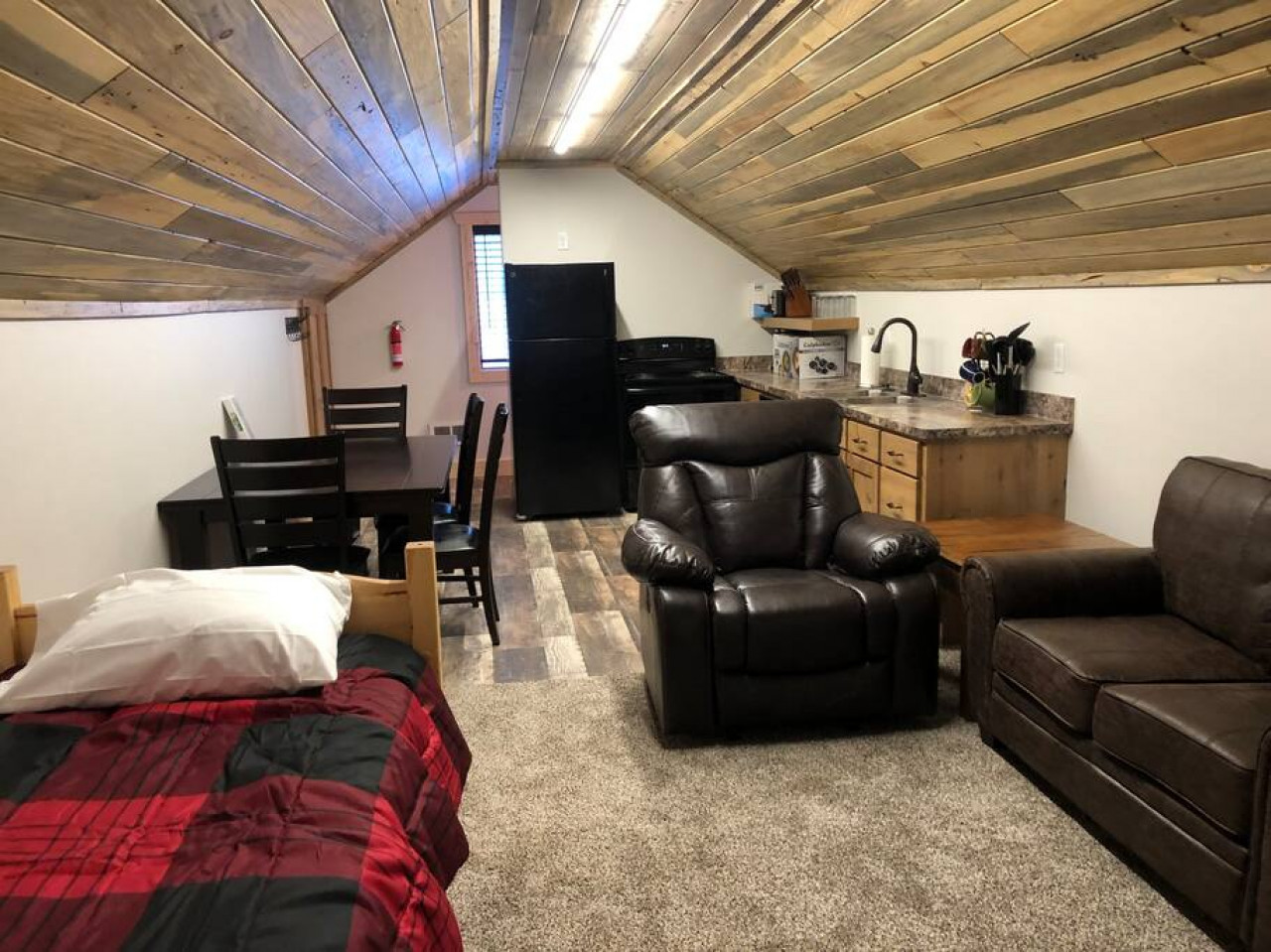 comfy furniture and an extra twin in the living room space