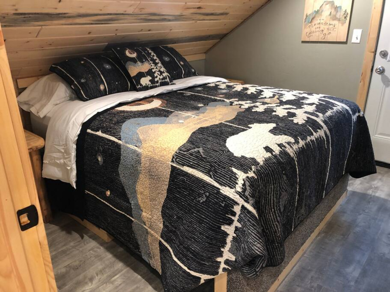 Bedroom with a queen and a door that walks onto a balcony