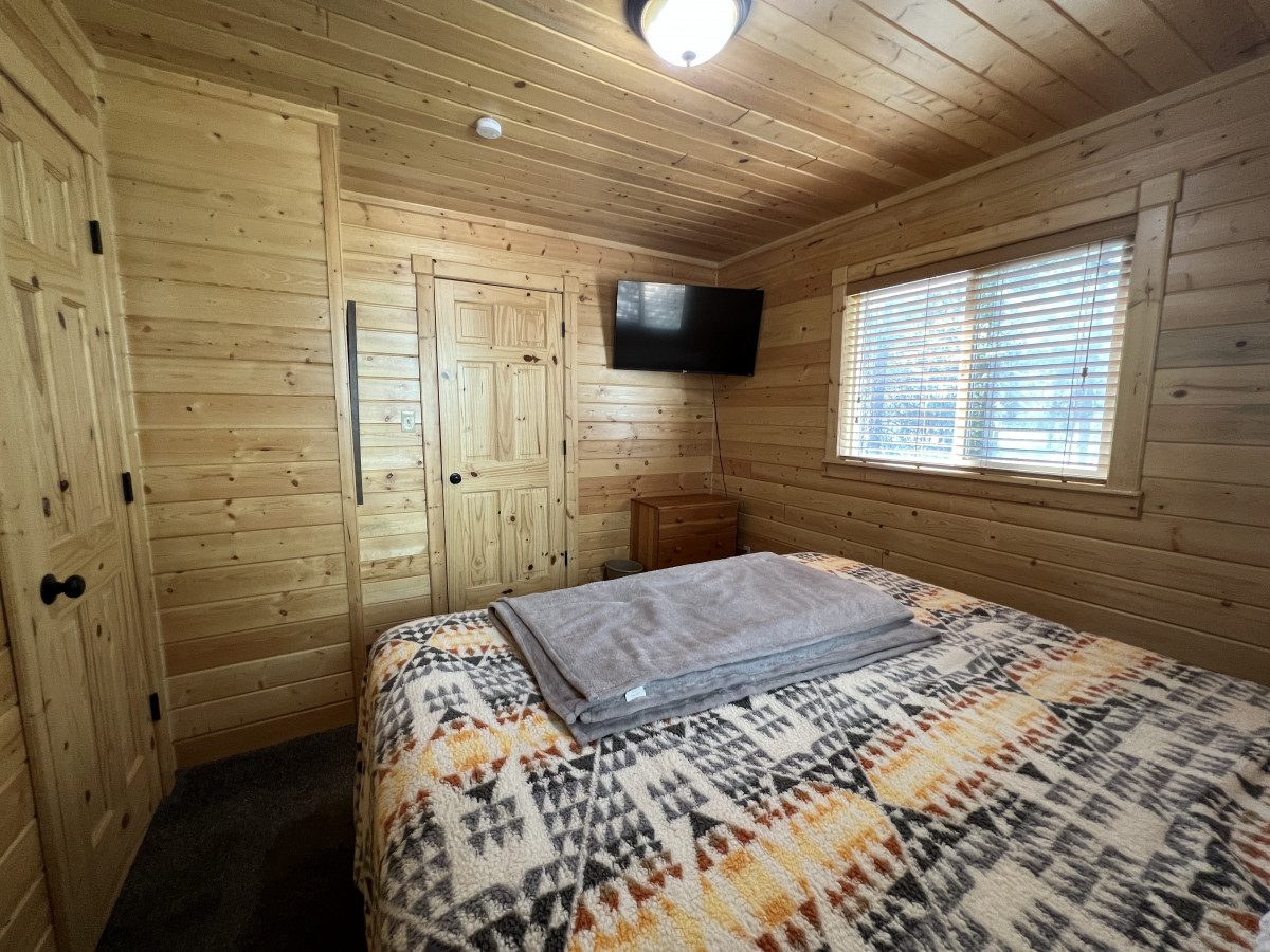 Closet space and TV in main floor bedroom