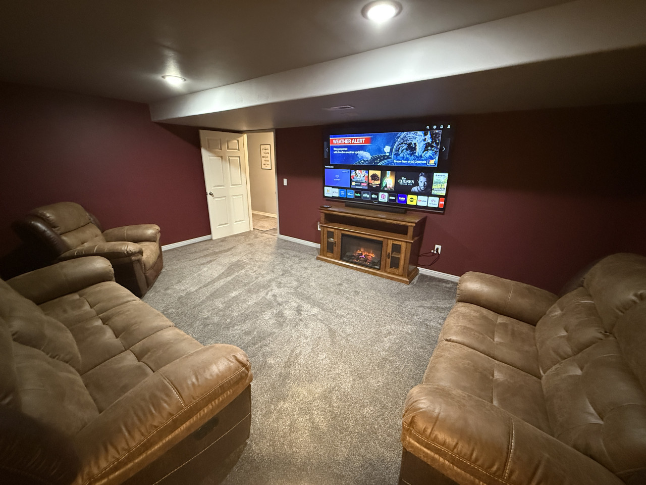 Stream your favorite show or movies with comfy couches & electric fireplace in the basement