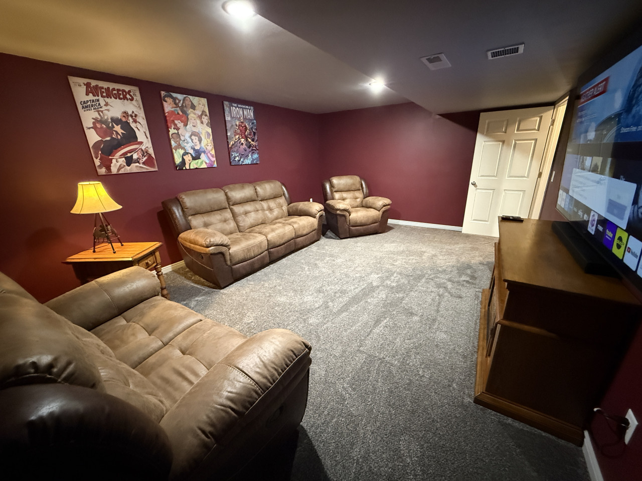 Stream your favorite show or movies with comfy couches & electric fireplace in the basement