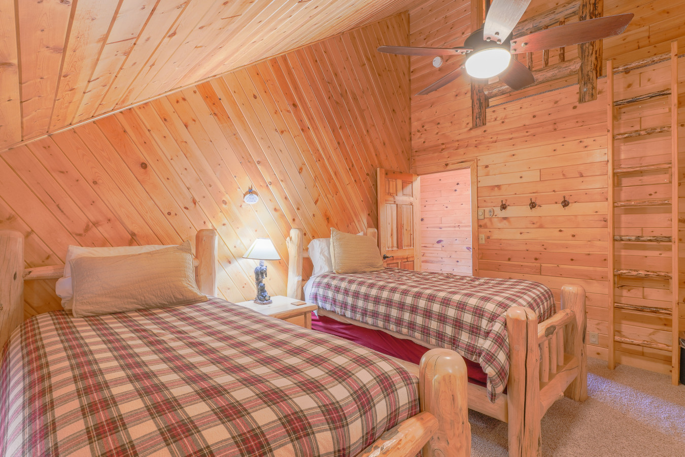 Upstairs bedroom with two twin beds and an upper loft for kids