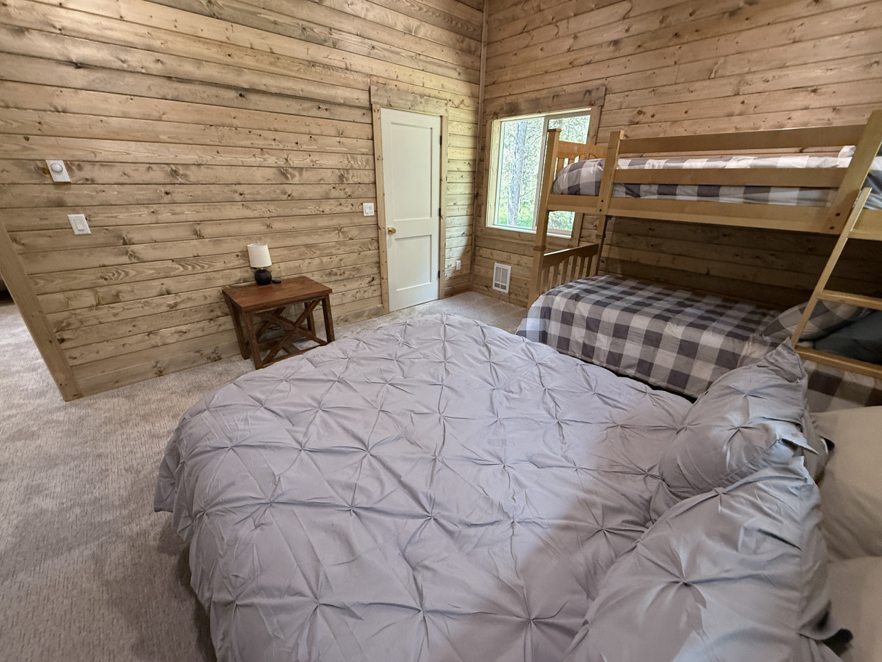 Bedroom upstairs with a queen and bunk bed
