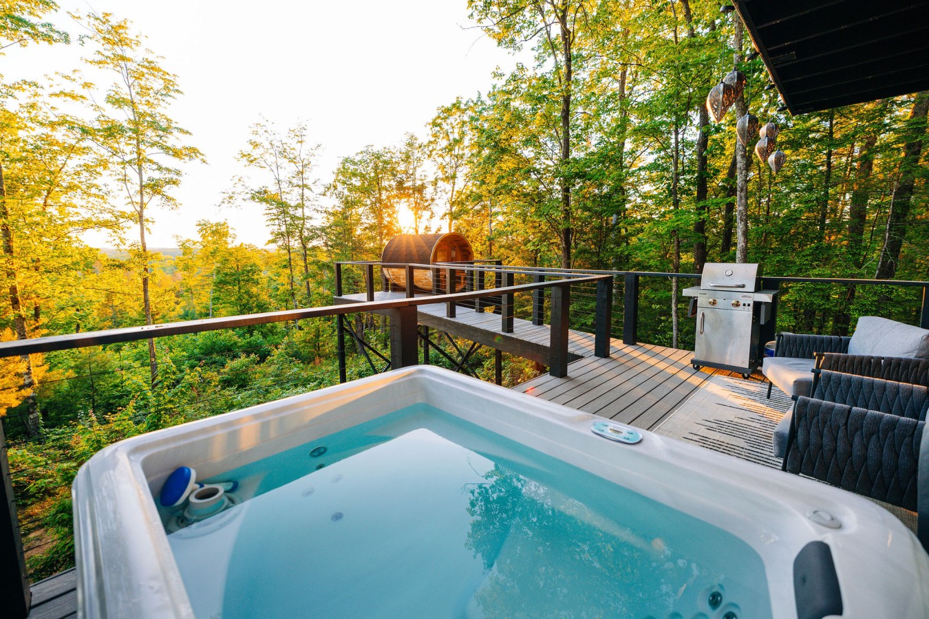 Golden-hour deck, hot tub and sauna at The Onyx, a Hideaways cabin in the Gorge