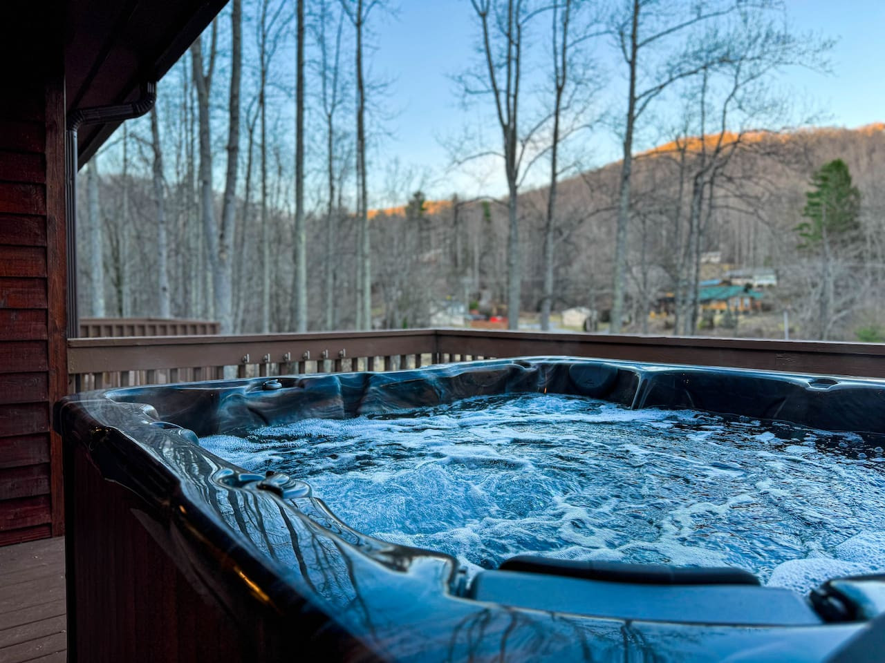Peaceful upper deck with a clean hot tub and mountain views.