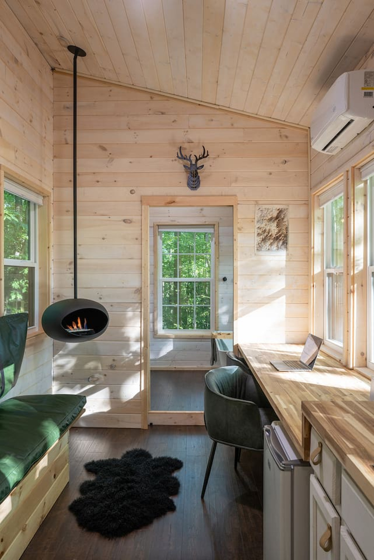 Brand new 2024 luxury tiny house in the dreamy Whisper Woods, equipped with an outdoor shower, fire pit,  soaking tub, and fireplace.