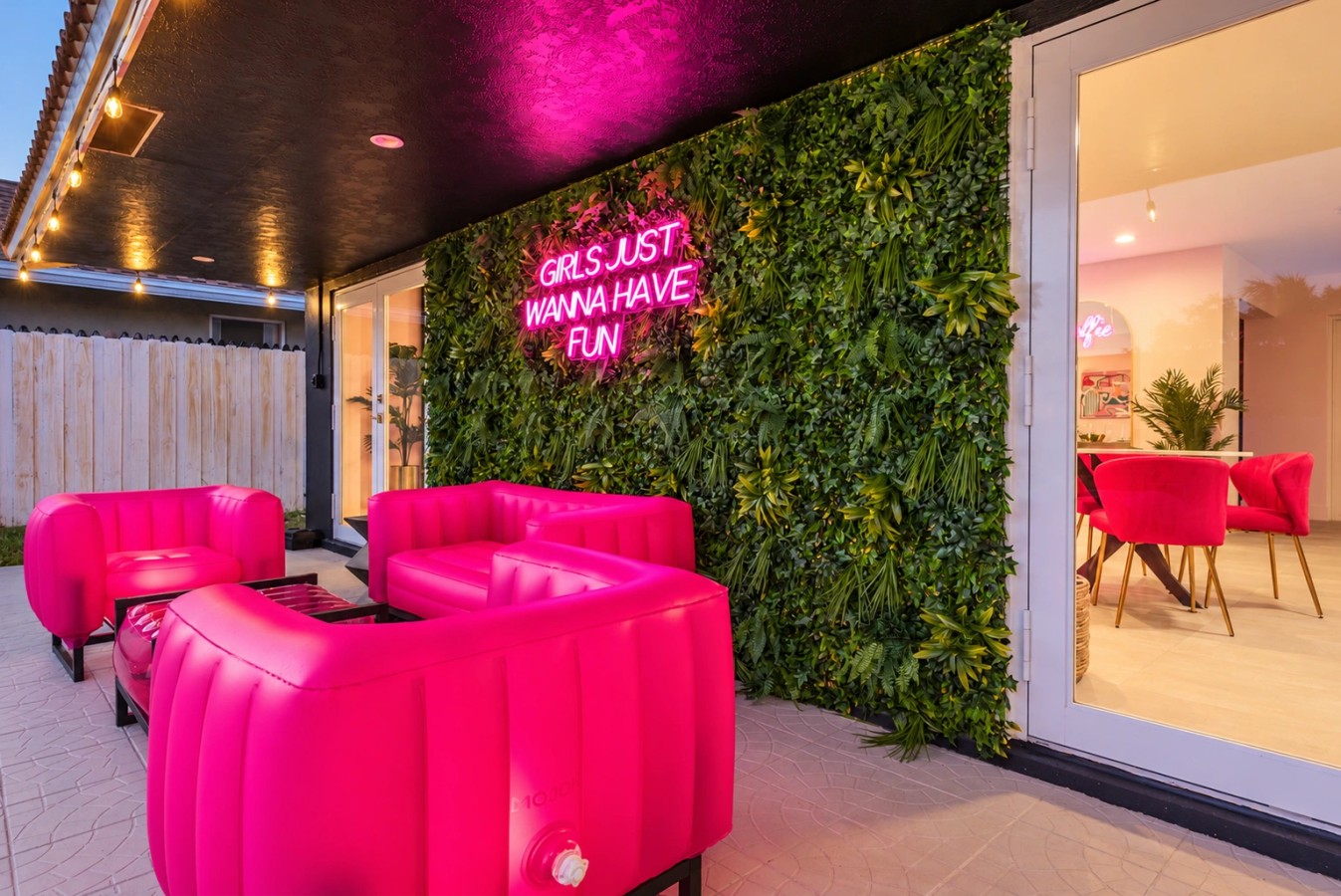 Swimming pool and bright pink patio seating at The Jungle