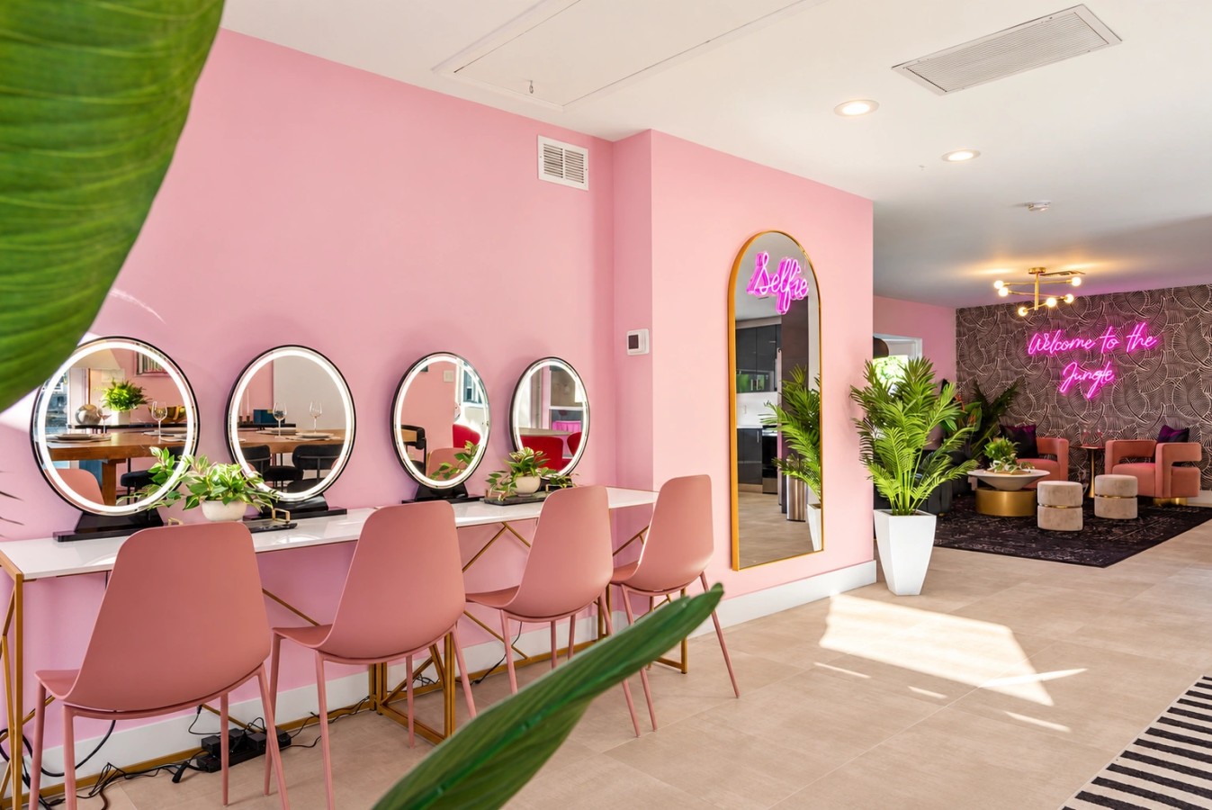 Pink get-ready room with mirrored styling stations