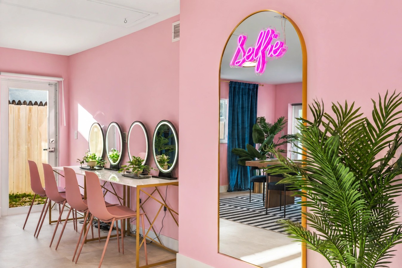 Pink get-ready room with mirrored styling stations