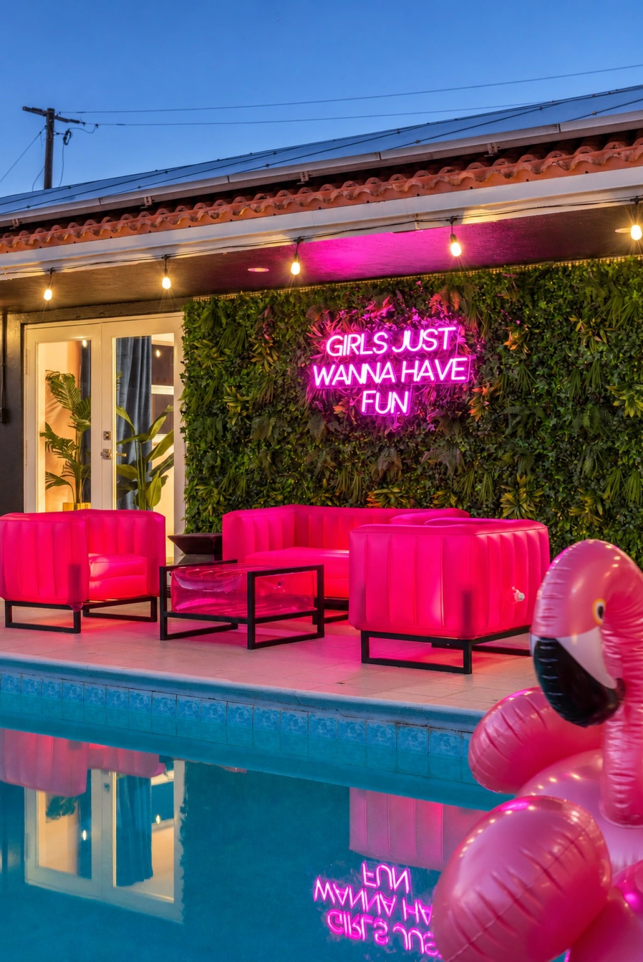 Swimming pool and bright pink patio seating at The Jungle