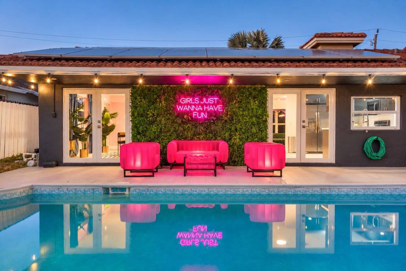 Swimming pool and bright pink patio seating at The Jungle