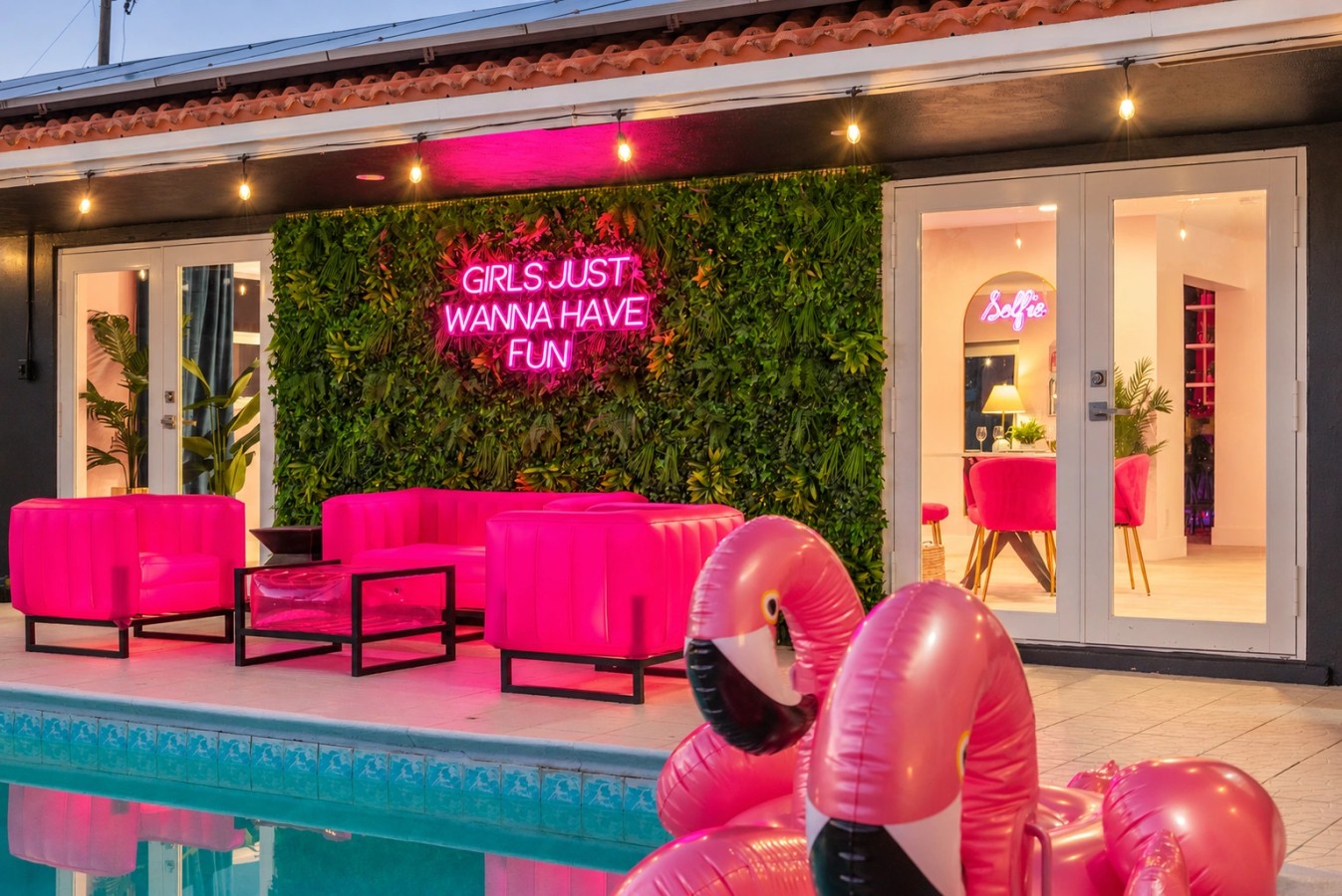 Swimming pool and bright pink patio seating at The Jungle