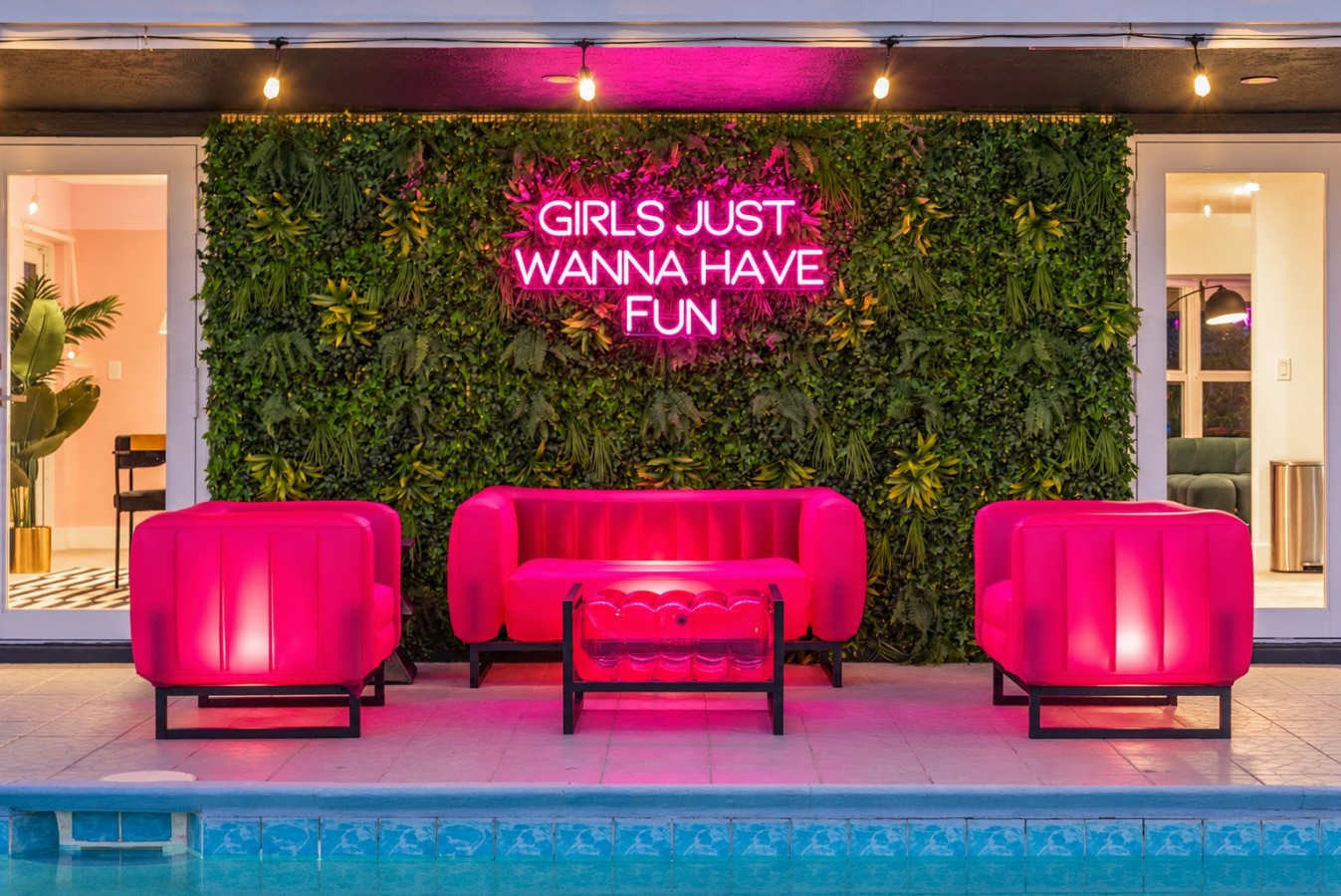 Swimming pool and bright pink patio seating at The Jungle