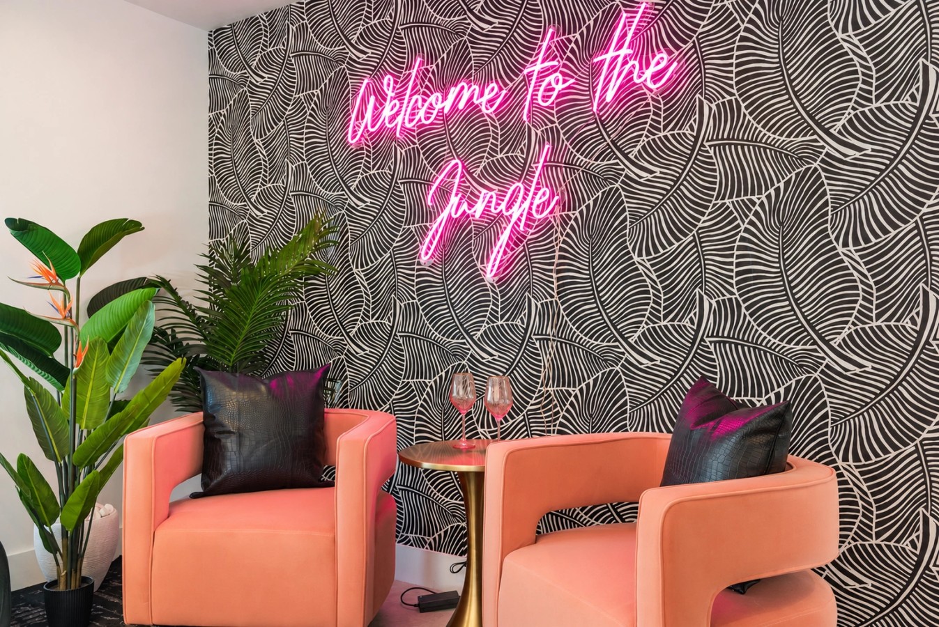 Welcome to The Jungle neon sign and seating