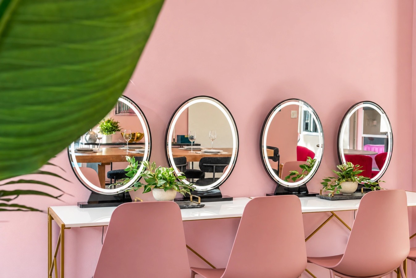 Pink get-ready room with mirrored styling stations