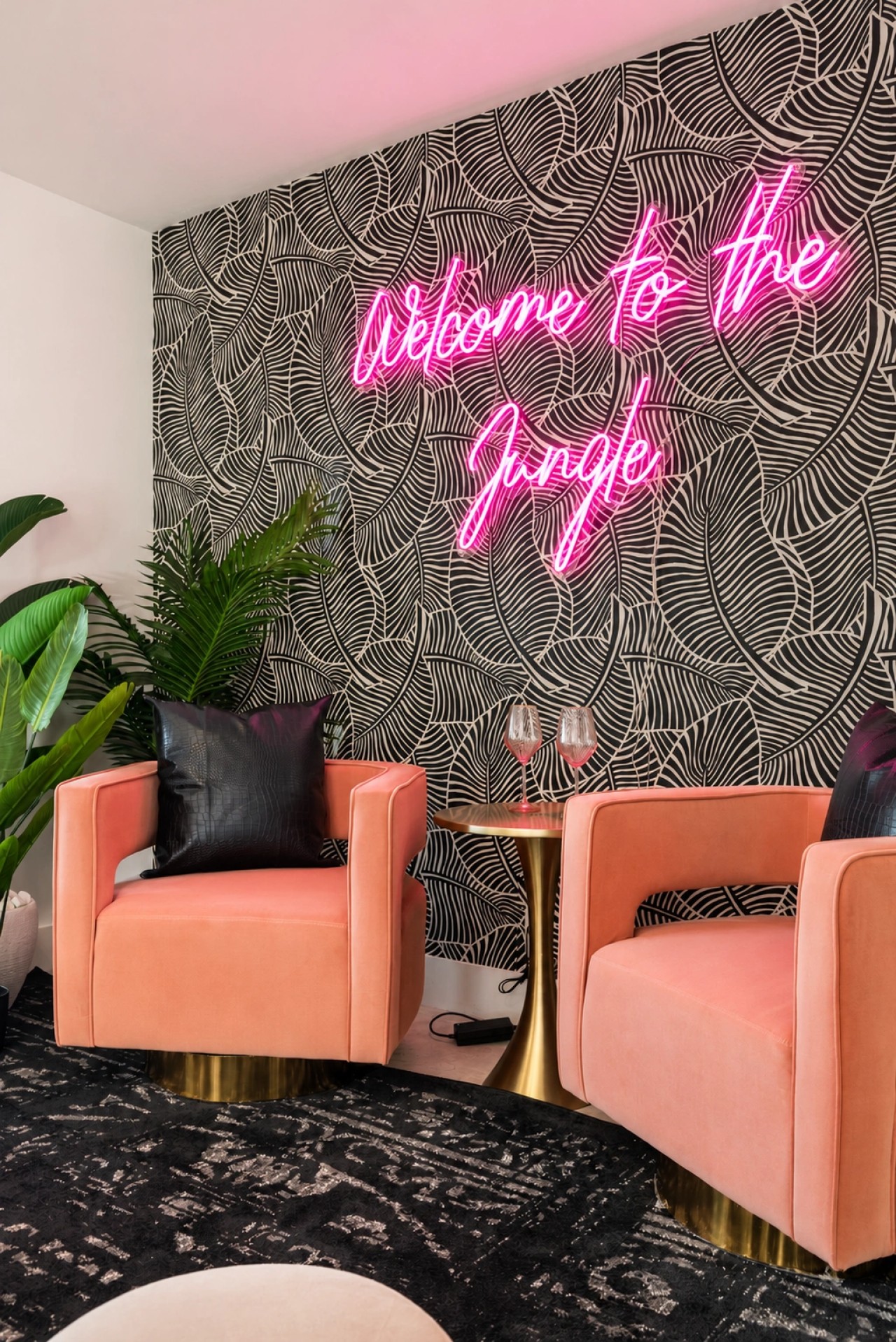 Welcome to The Jungle neon sign and seating