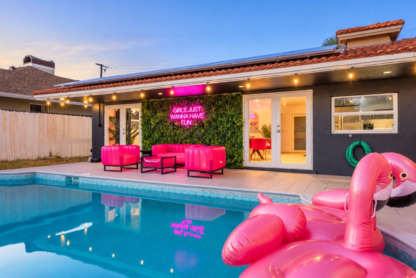 Swimming pool and bright pink patio seating at The Jungle