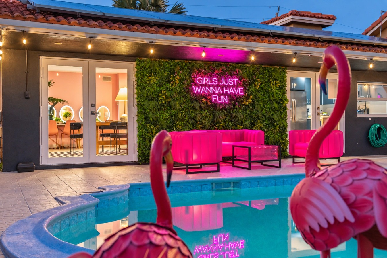 Swimming pool and bright pink patio seating at The Jungle
