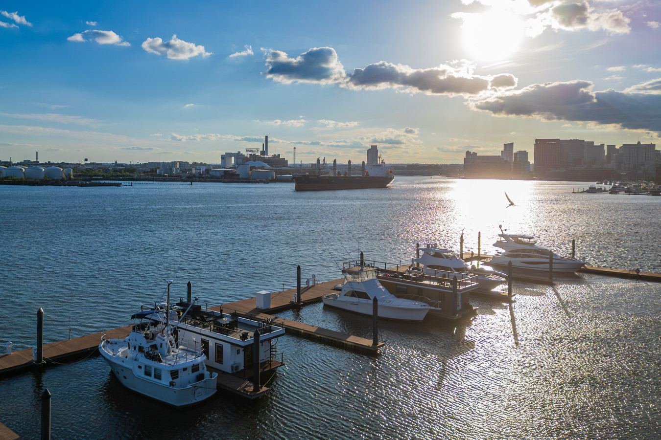 Sun-drenched aerial of our floating neighborhood — houseboats and yachts basking in the harbor light.