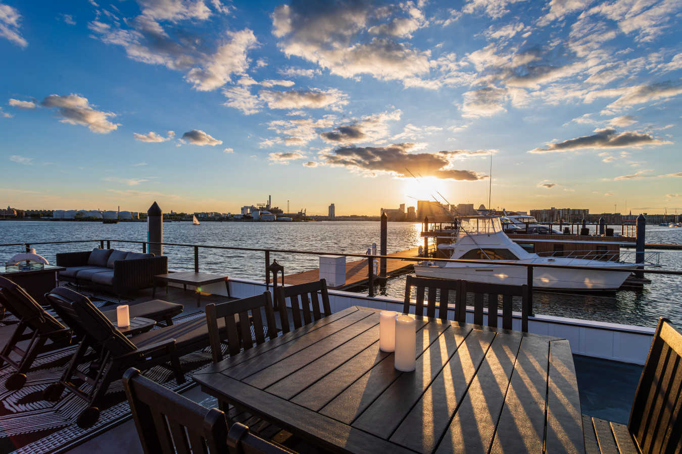 Candlelit evenings on the rooftop deck — dinner with a view of sailboats, yachts, and a spectacular harbor sunset.