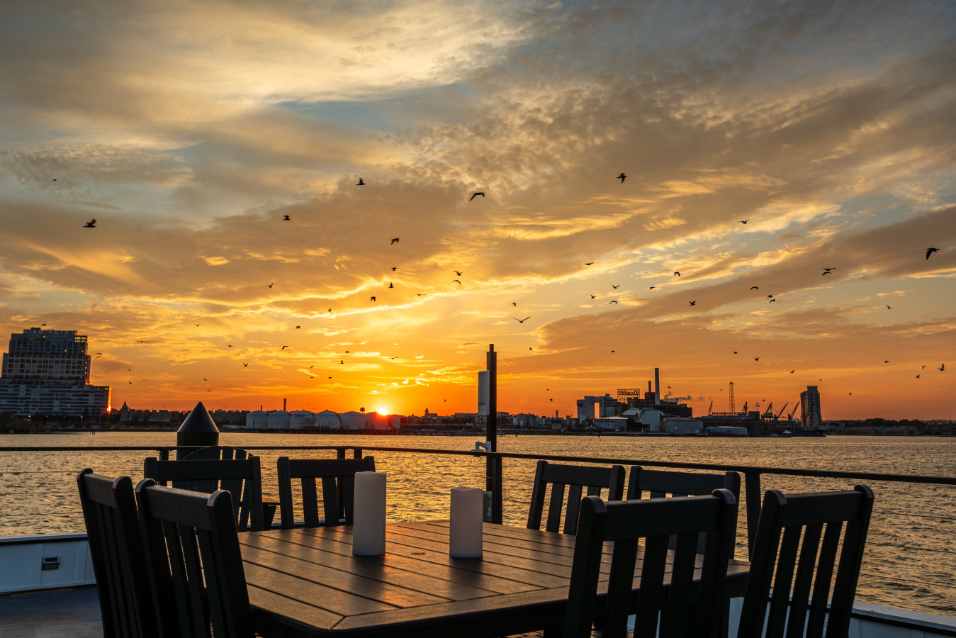 Dine under a fiery sunset sky on the private rooftop deck — unobstructed harbor views that take your breath away.