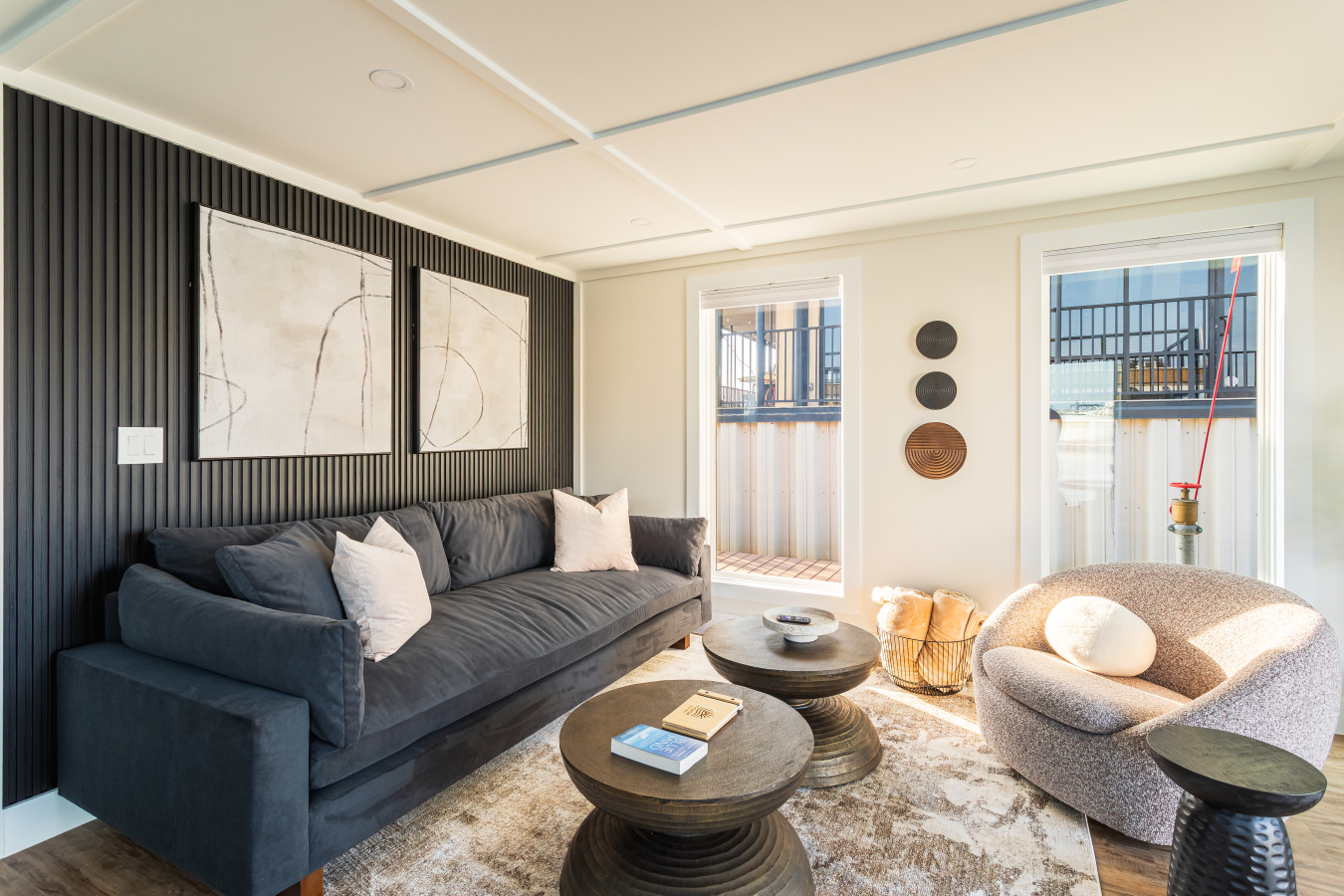 Sink into the plush sofa in this beautifully styled living room with designer accent furniture.