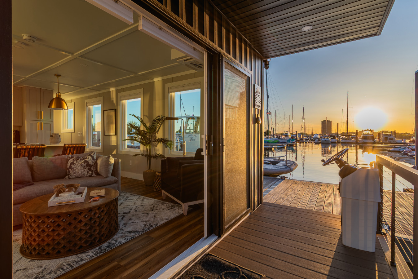 Slide open the door and step onto your private deck as the sun sets over the marina, with the warm glow of the suite waiting just behind you.