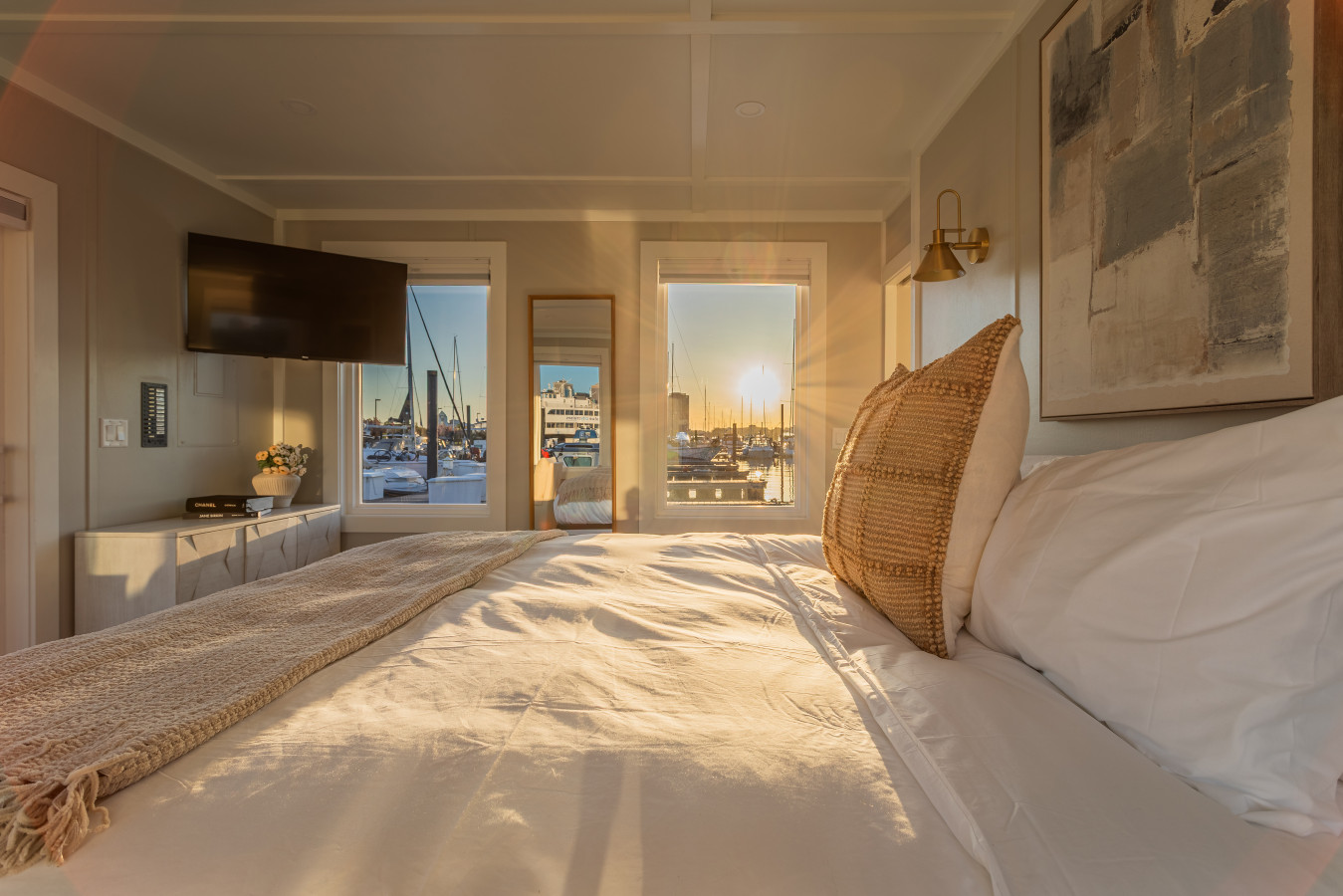 Sunset pours across the king bed as the marina glows outside the windows, the kind of evening that makes you want to stay one more night.