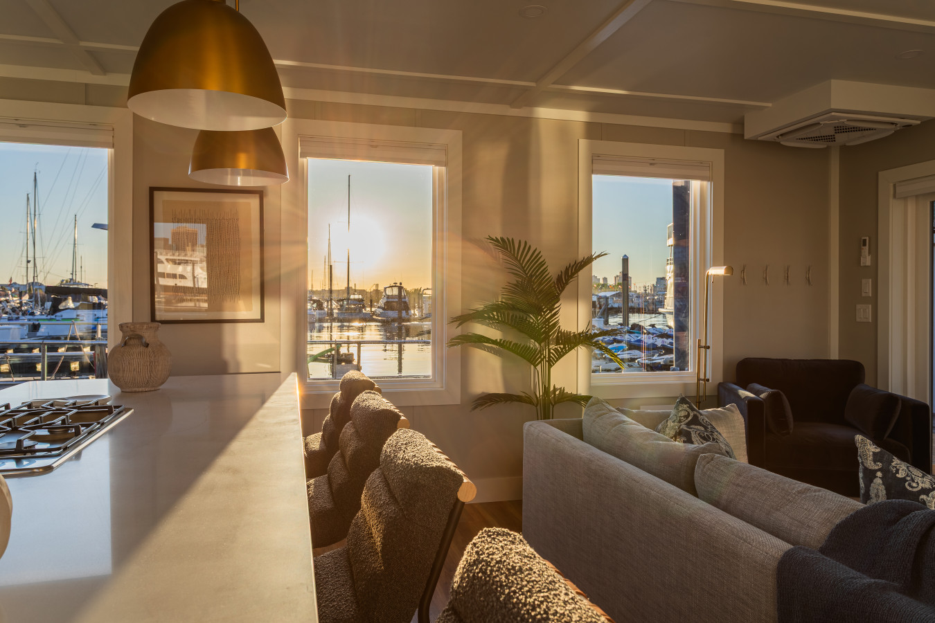 As the sun drops over the marina, the entire living space fills with golden light, turning an evening in the suite into something worth staying for.